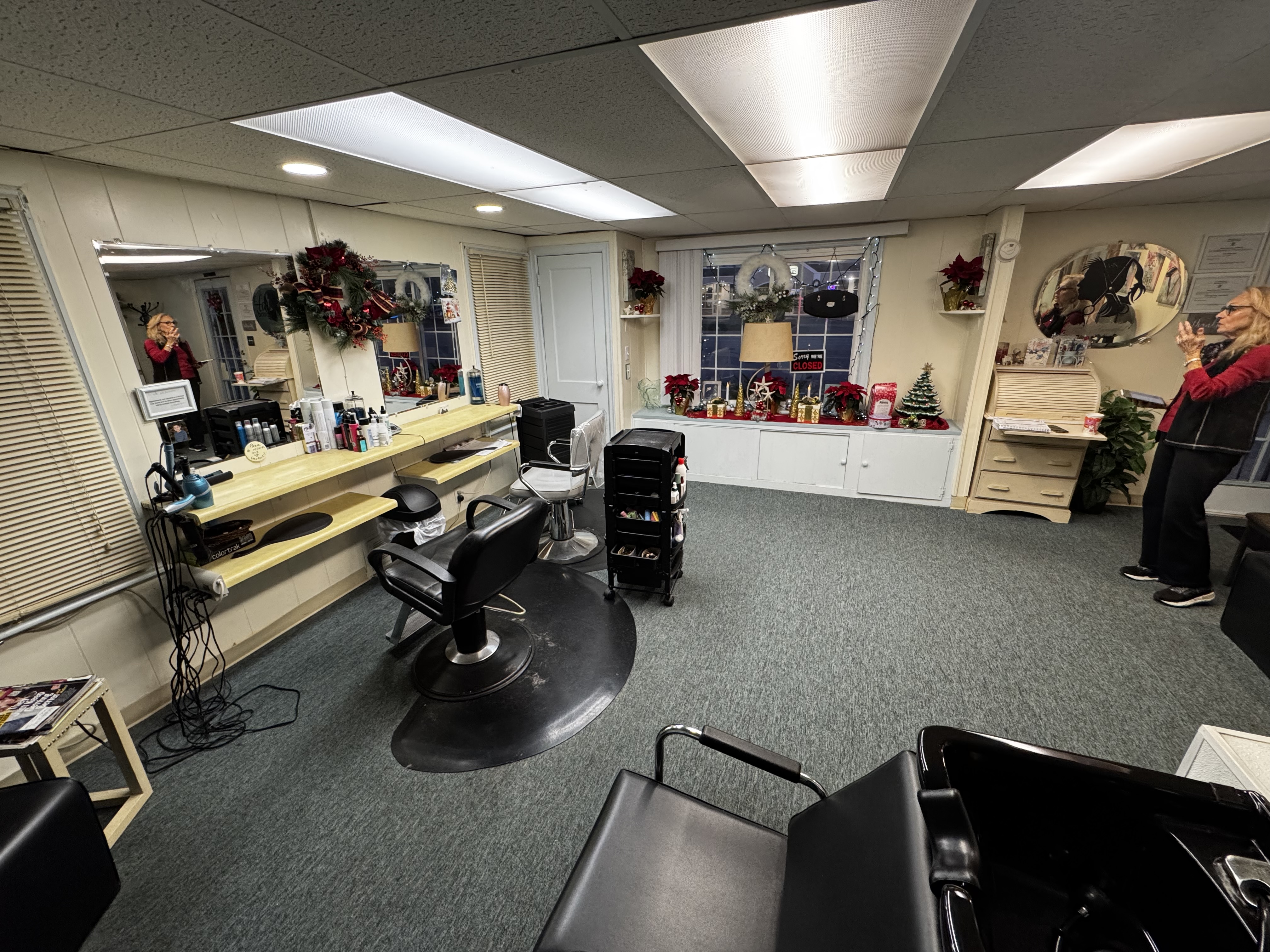 Interior view of Modern Beauty Salon showing styling stations, hair washing area, and welcoming decor